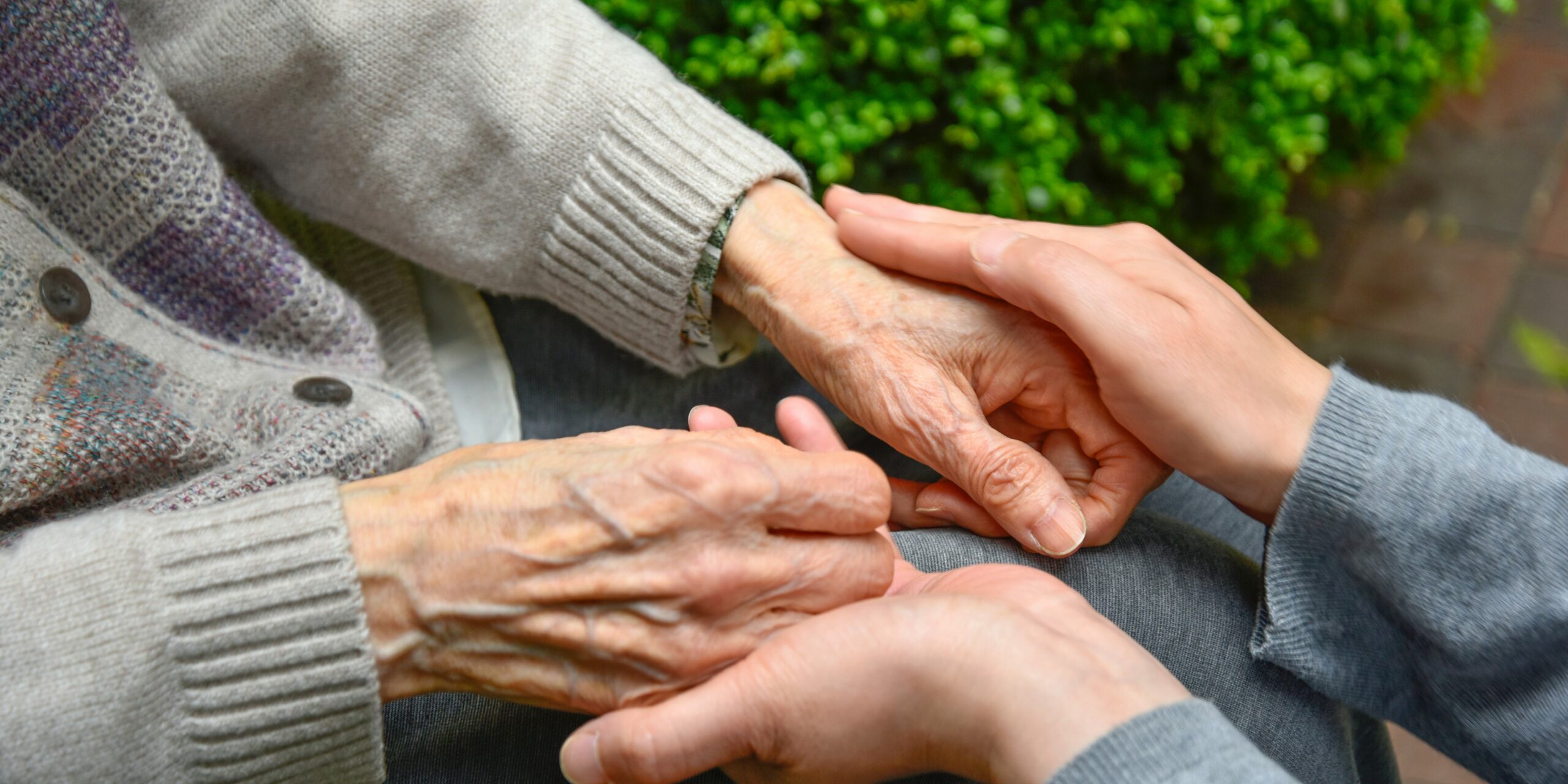 Touches the hands of an old woman - Concept of Elderly care.